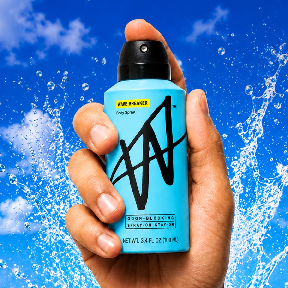 Hand holding W Wave Breaker Body Spray against a water splash
